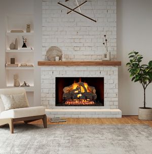 Real Fyre Charred Evergreen Oak gas logs burning in a white-brick masonry fireplace